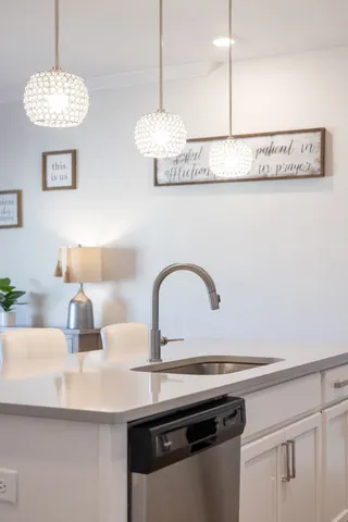 a kitchen with kitchen island white cabinets and stainless steel appliances