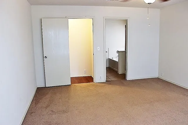 a view of an empty room with a bathroom