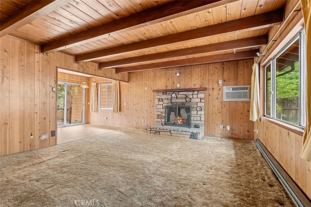 1056 Lark Road Wrightwood, CA 92397 - Photo 5 of 40 a view of an empty room with a fireplace and a window