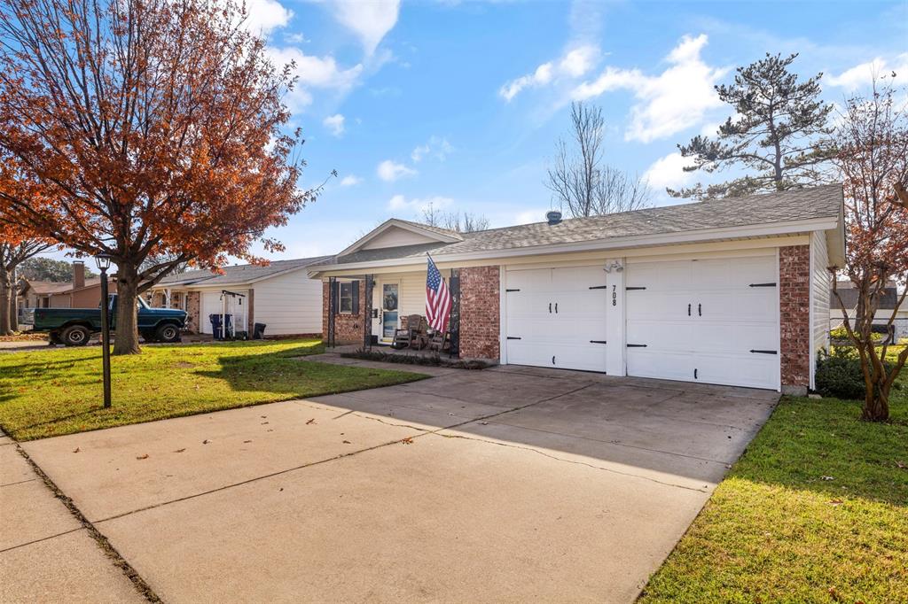 708 East Prairie View Road Crowley, TX 76036 - Photo 21 of 21 Exterior featuring a two-car garage, brick facade, covered front porch, and a concrete driveway
