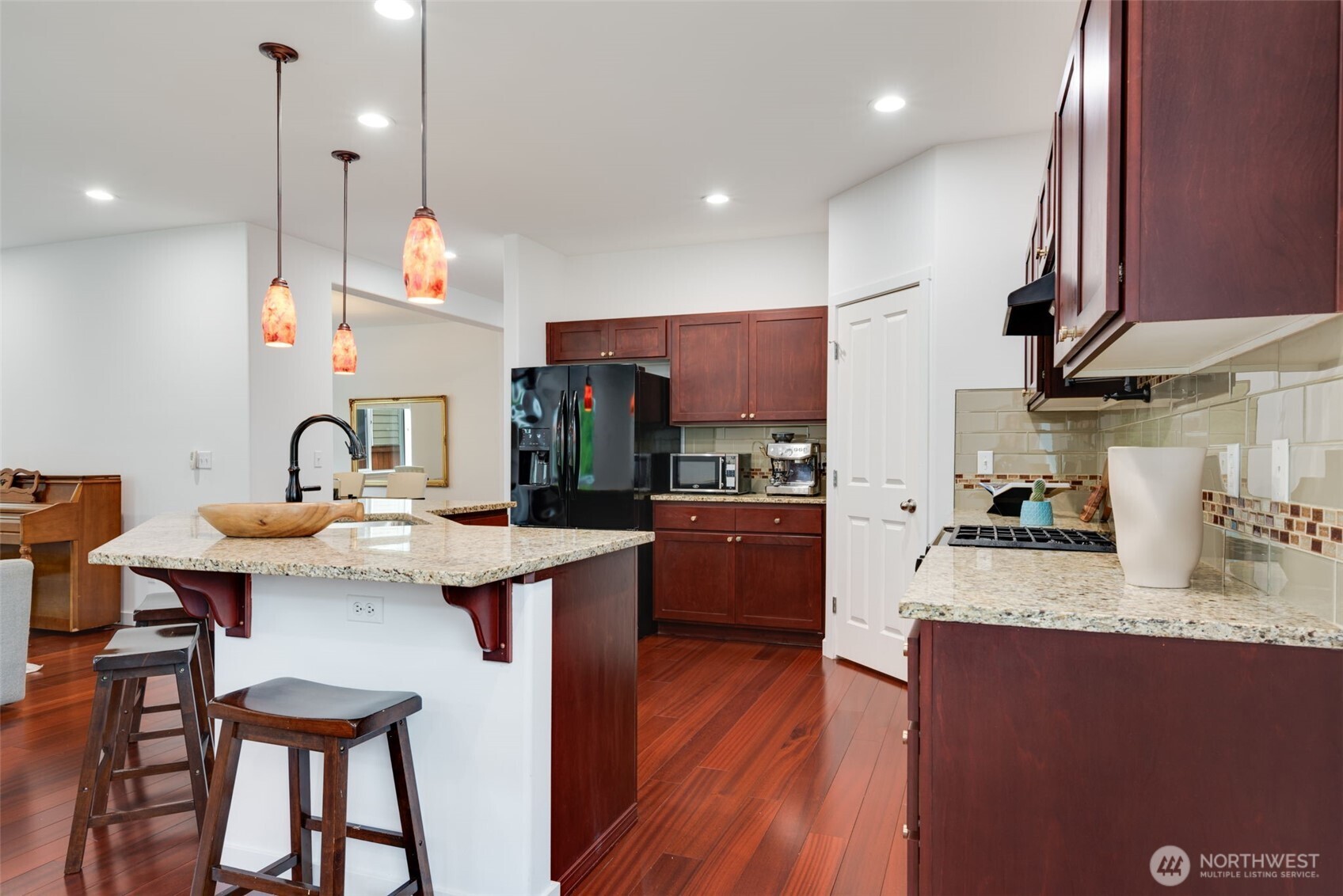 17026 Southeast 263rd Street Covington, WA 98042 - Photo 12 of 40 a kitchen with granite countertop a sink appliances and cabinets