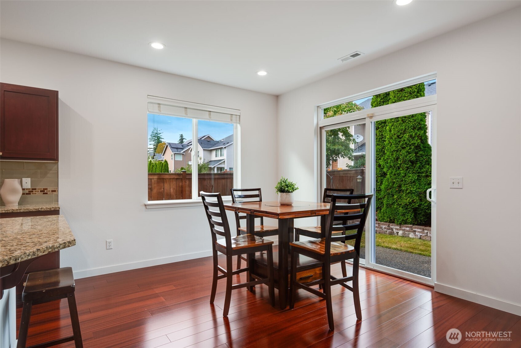 17026 Southeast 263rd Street Covington, WA 98042 - Photo 15 of 40 a view of a dining room with furniture window and wooden floor