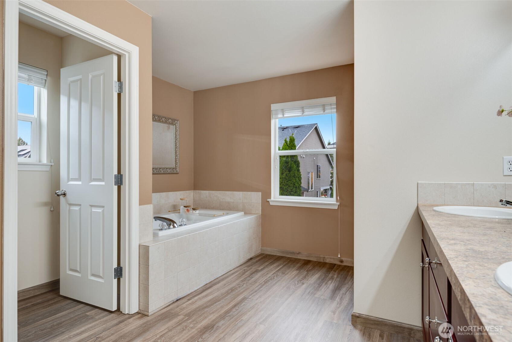 17026 Southeast 263rd Street Covington, WA 98042 - Photo 22 of 40 a bathroom with a tub sink and mirror