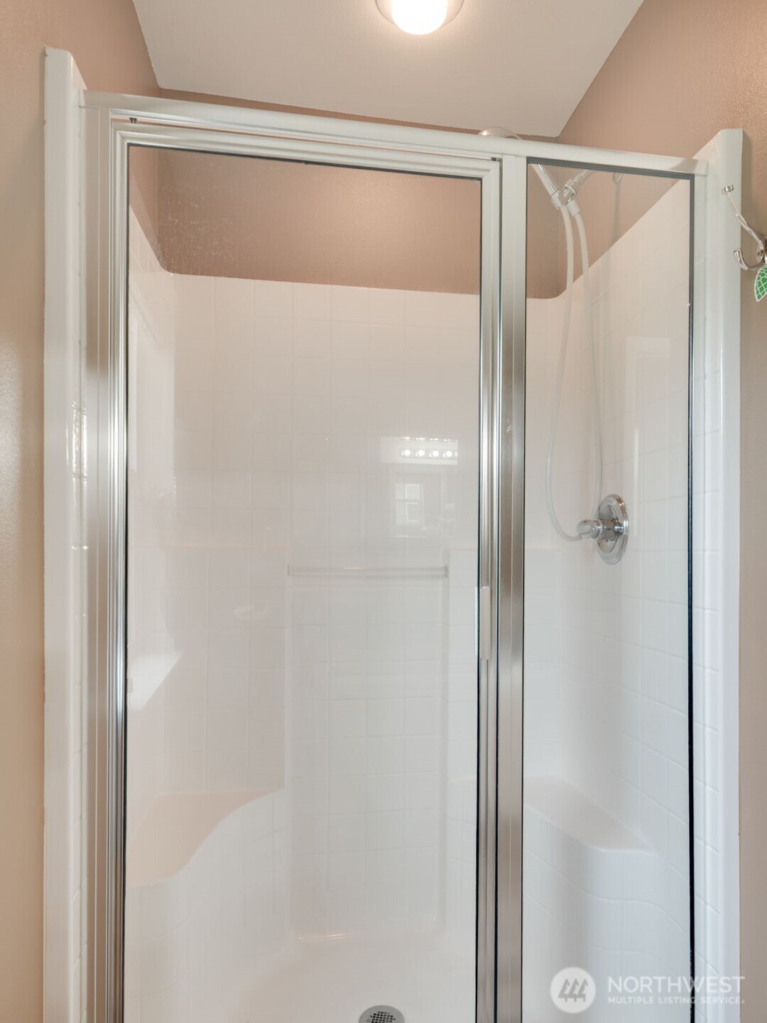 17026 Southeast 263rd Street Covington, WA 98042 - Photo 24 of 40 a bathroom with a glass shower door