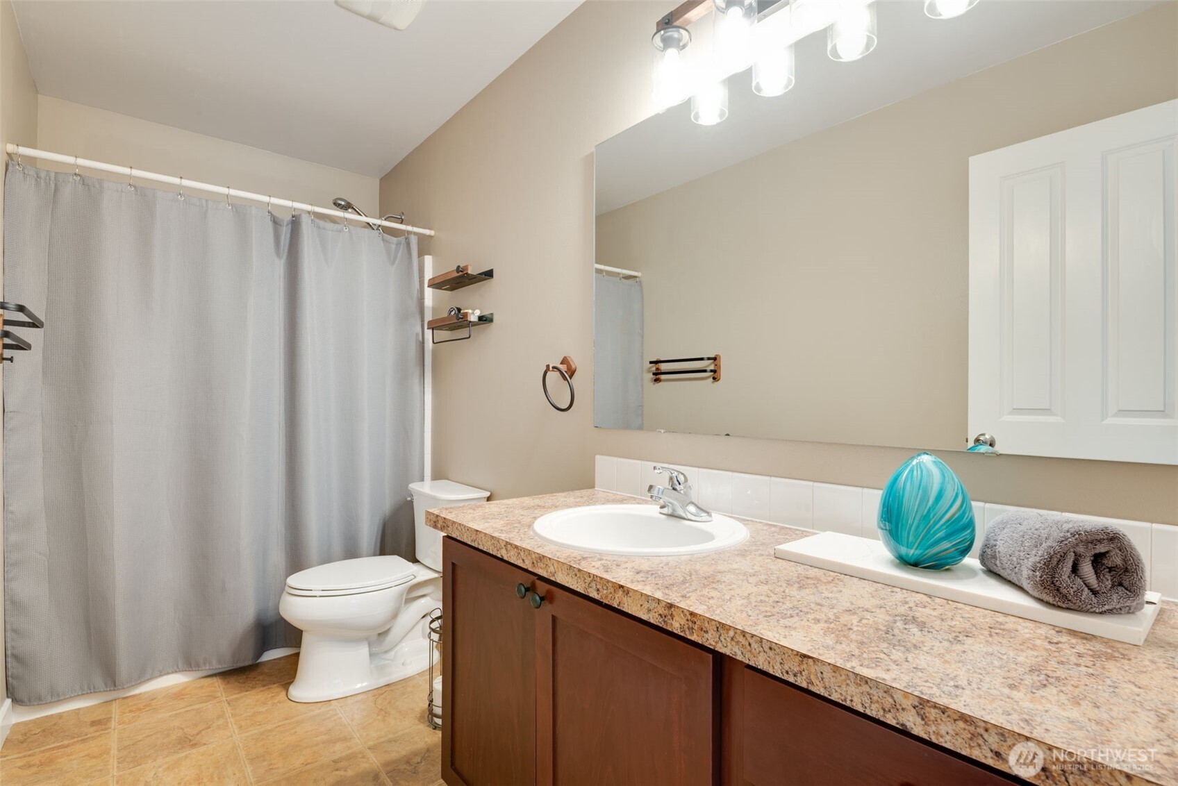 17026 Southeast 263rd Street Covington, WA 98042 - Photo 31 of 40 a bathroom with a granite countertop sink a toilet and a mirror