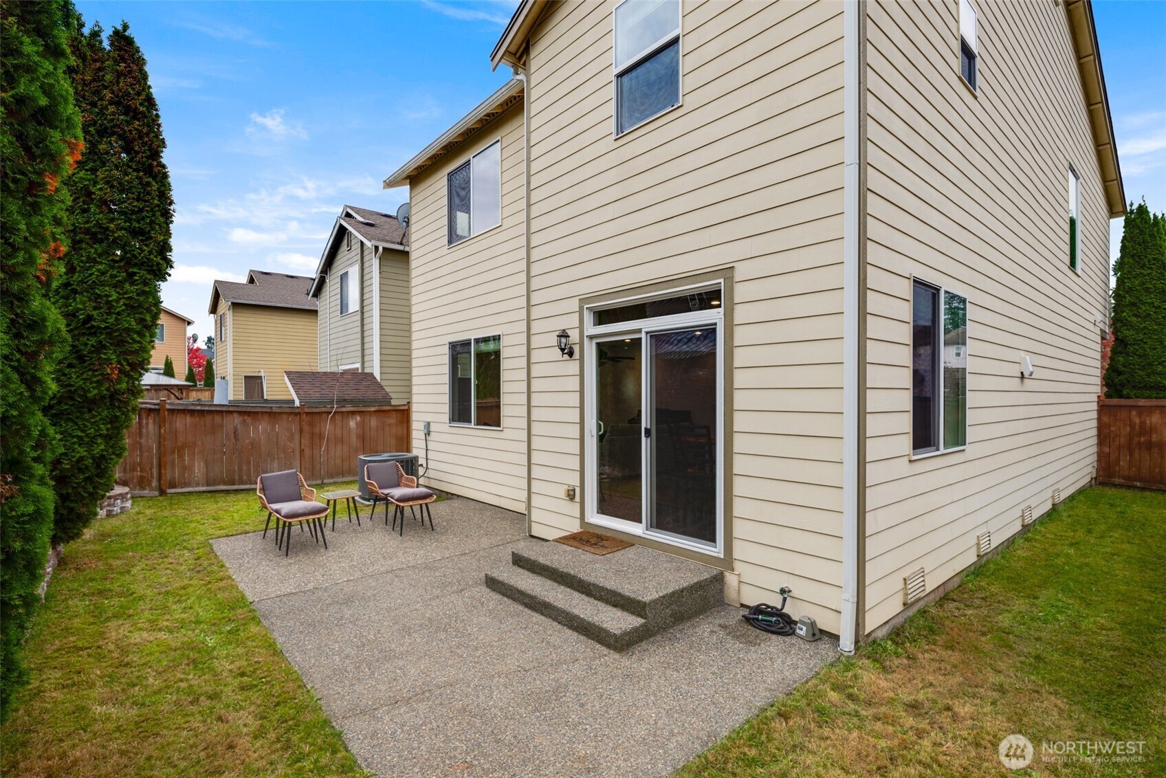 17026 Southeast 263rd Street Covington, WA 98042 - Photo 36 of 40 a view of a patio with table and chairs with wooden fence and plants