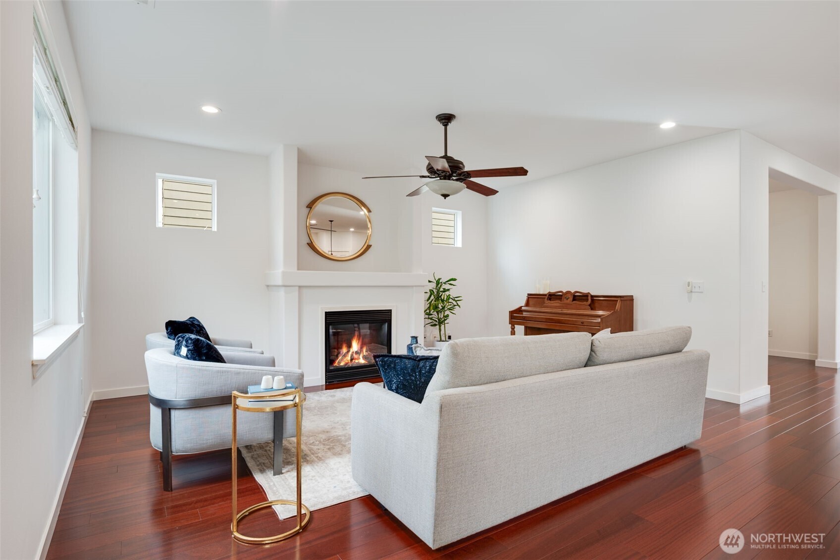 17026 Southeast 263rd Street Covington, WA 98042 - Photo 5 of 40 a living room with furniture a clock and a fireplace
