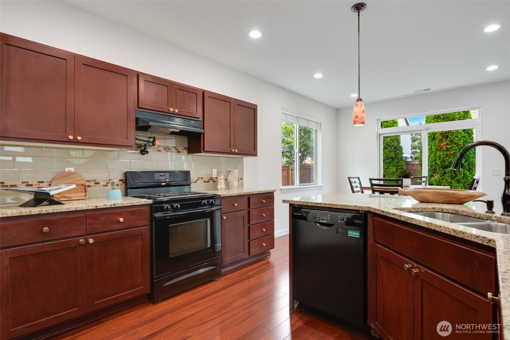 17026 Southeast 263rd Street Covington, WA 98042 - Photo 9 of 40 a kitchen with a sink stove and cabinets