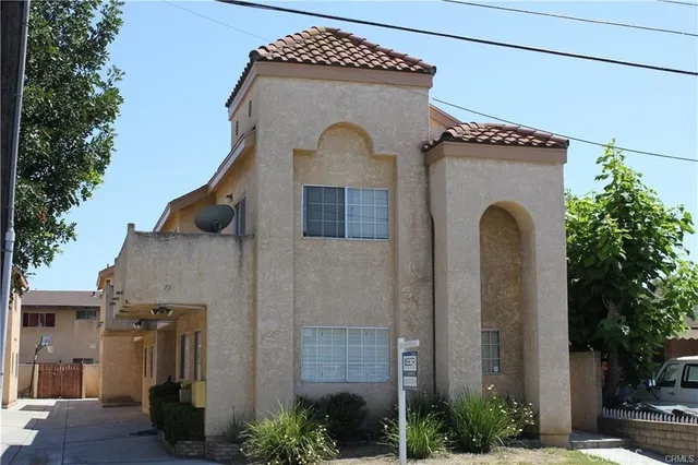 a front view of a house with plants