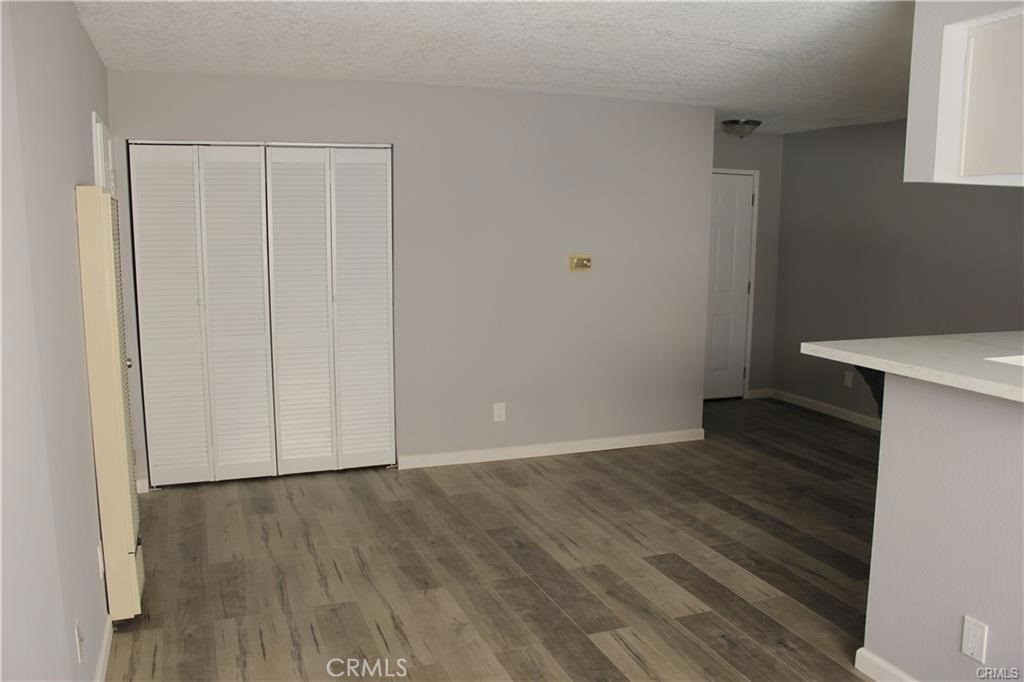 9734 Maple Street Bellflower, CA 90706 - Photo 2 of 11 a view of an empty room with wooden floor