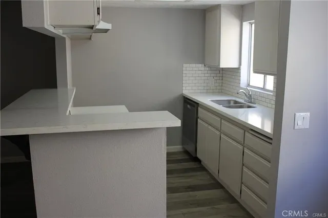 a kitchen with a sink and a window