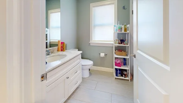 a view of bathroom with a baby crib and a sink