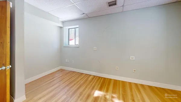 a view of a room with wooden floor and a window
