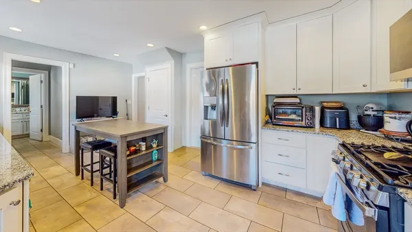 a kitchen with stainless steel appliances a stove a refrigerator and a refrigerator