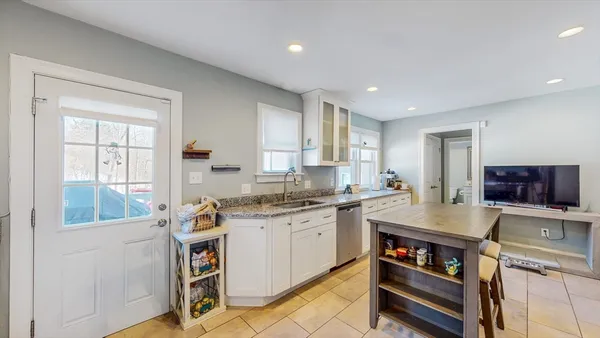 a kitchen with a stove a sink and a refrigerator
