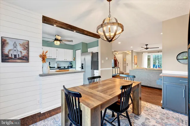 a kitchen with a dining table and chairs
