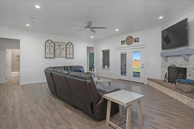 a living room with furniture a flat screen tv and a fireplace