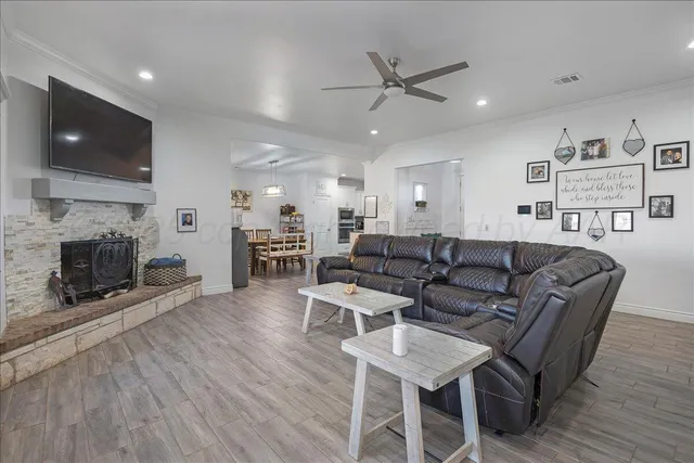 a living room with fireplace furniture and a flat screen tv
