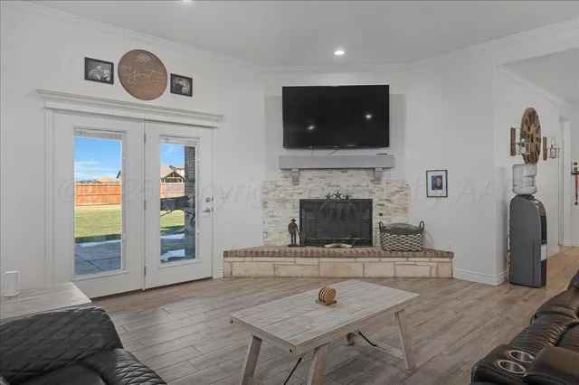 a kitchen with stainless steel appliances a dining table chairs and wooden floor