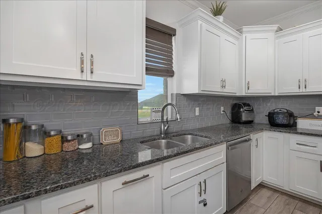 a kitchen with granite countertop a stove oven and refrigerator