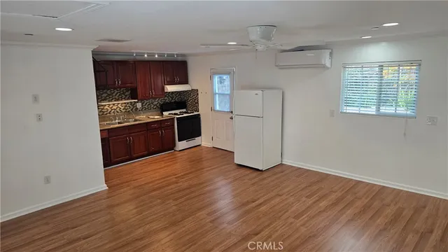 a kitchen with granite countertop a stove and a refrigerator