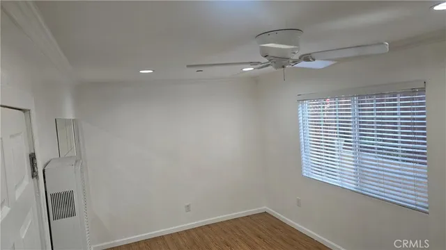 a view of a room with a ceiling fan and a window