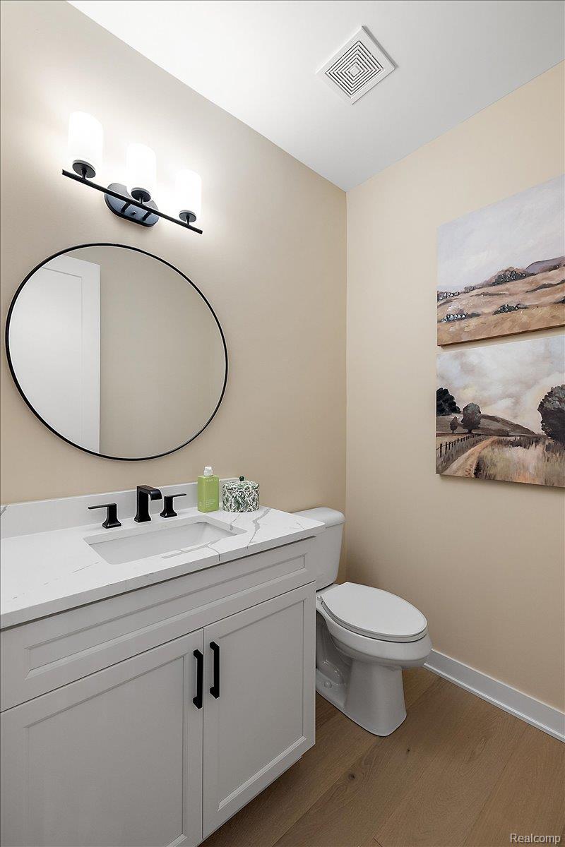 2032 Breckenridge Court, Unit 9 Rochester, MI 48309 - Photo 29 of 39 Half bath featuring dark wood-type flooring and vanity