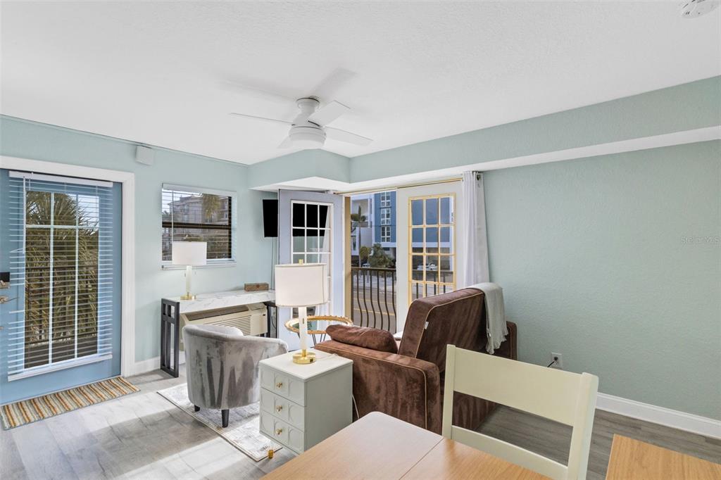 16333 Gulf Boulevard, Unit 215 Redington Beach, FL 33708 - Photo 11 of 38 a view of a livingroom with furniture wooden floor and windows