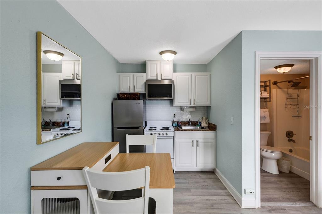 16333 Gulf Boulevard, Unit 215 Redington Beach, FL 33708 - Photo 13 of 38 a kitchen with stainless steel appliances a stove a sink and a refrigerator