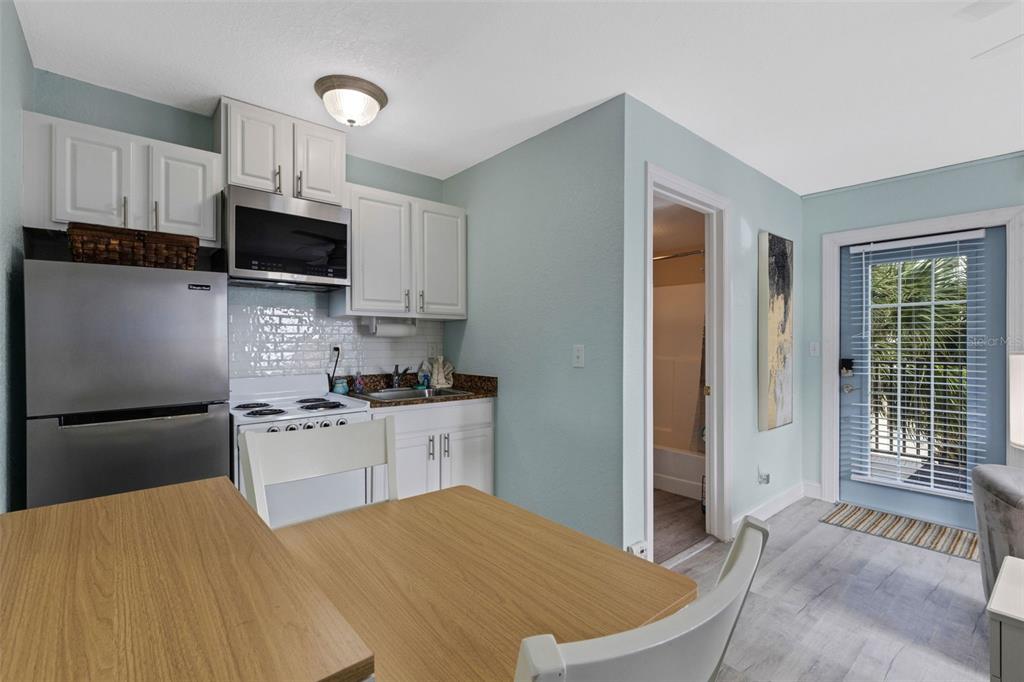 16333 Gulf Boulevard, Unit 215 Redington Beach, FL 33708 - Photo 14 of 38 a kitchen with stainless steel appliances granite countertop a refrigerator sink and stove