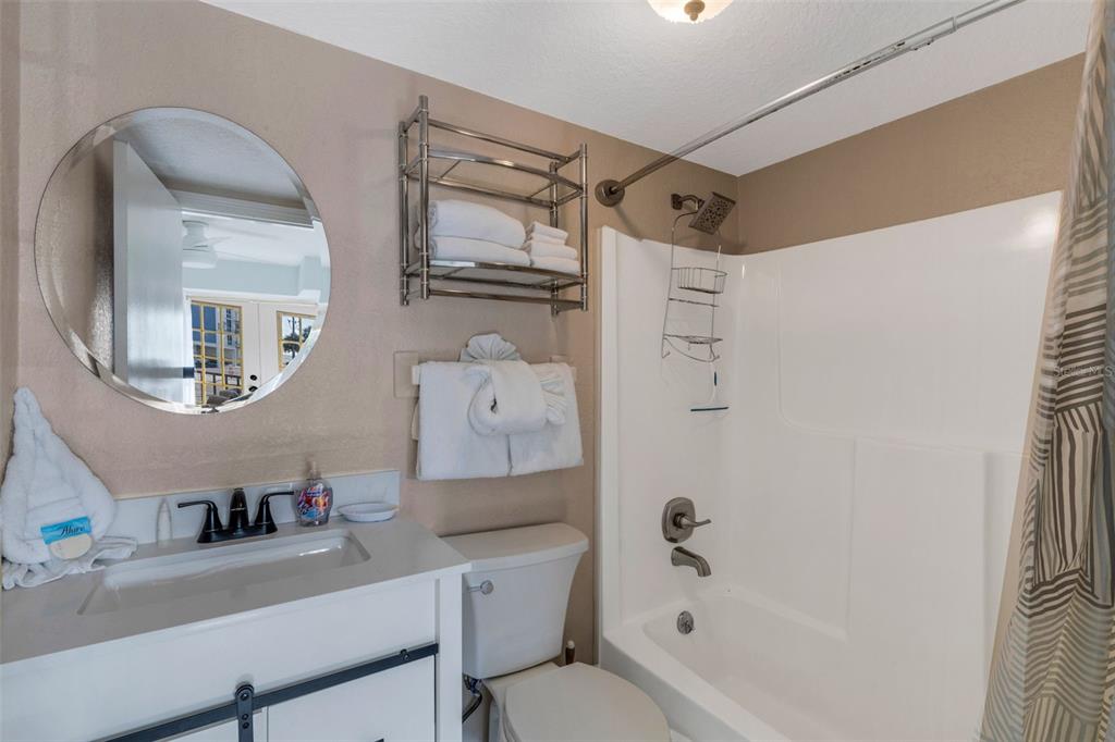 16333 Gulf Boulevard, Unit 215 Redington Beach, FL 33708 - Photo 17 of 38 a bathroom with a bathtub a sink and a mirror