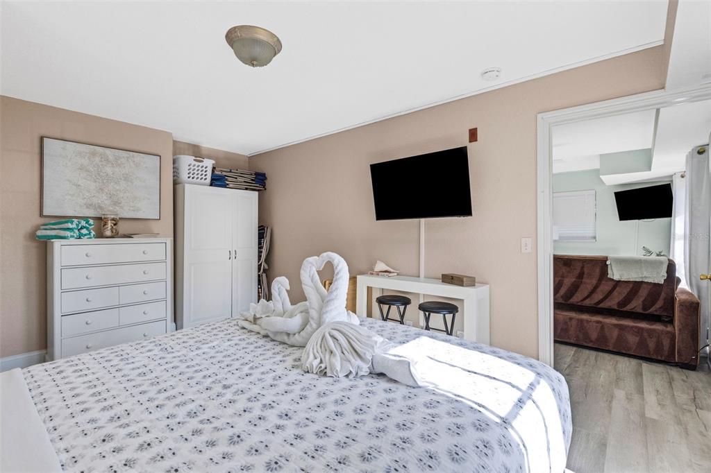 16333 Gulf Boulevard, Unit 215 Redington Beach, FL 33708 - Photo 19 of 38 a bedroom with a bed and a flat screen tv