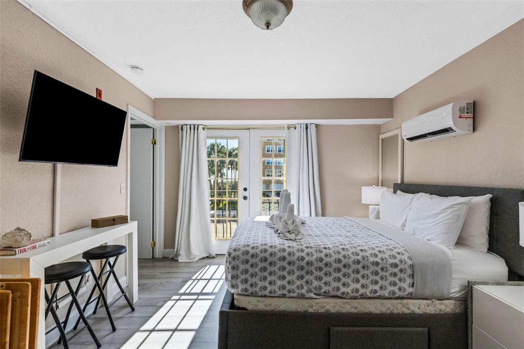 16333 Gulf Boulevard, Unit 215 Redington Beach, FL 33708 - Photo 21 of 38 a bedroom with a bed and a flat screen tv