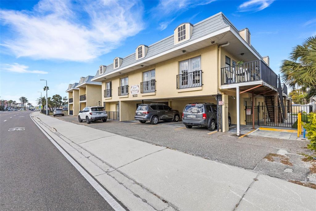 16333 Gulf Boulevard, Unit 215 Redington Beach, FL 33708 - Photo 33 of 38 a car parked in front of a building