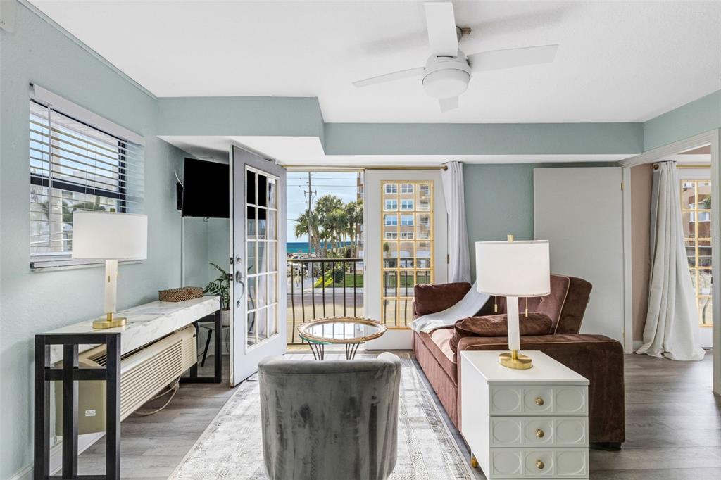 16333 Gulf Boulevard, Unit 215 Redington Beach, FL 33708 - Photo 7 of 38 a room with furniture a flat screen tv and a window