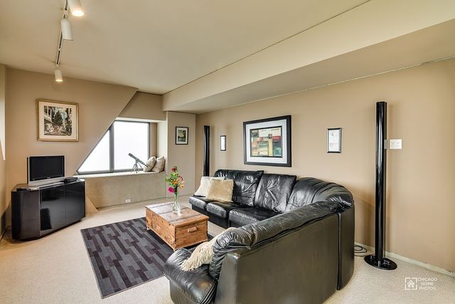 175 East Delaware Place, Unit 5609 Chicago, IL 60611 - Photo 14 of 28 a living room with furniture and a window