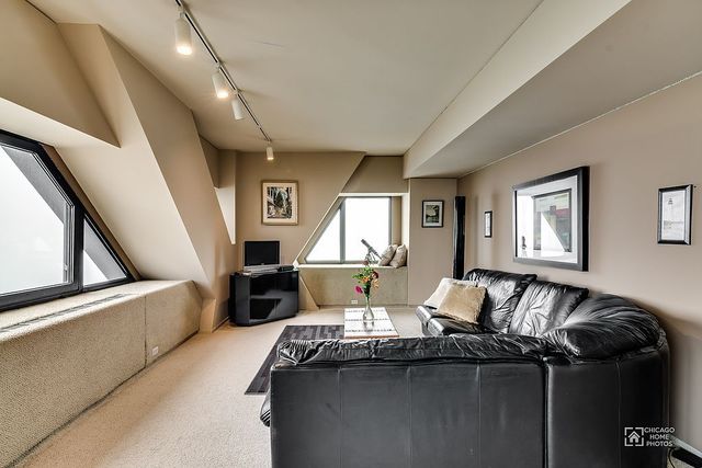 175 East Delaware Place, Unit 5609 Chicago, IL 60611 - Photo 15 of 28 a living room with furniture and a window