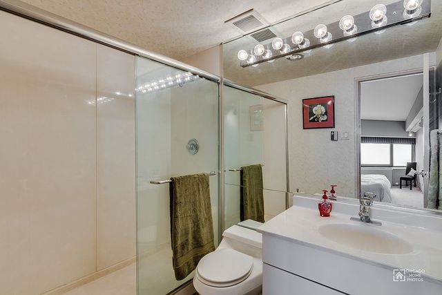 175 East Delaware Place, Unit 5609 Chicago, IL 60611 - Photo 19 of 28 a bathroom with a sink vanity mirror and toilet