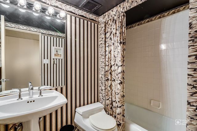 175 East Delaware Place, Unit 5609 Chicago, IL 60611 - Photo 20 of 28 a bathroom with a sink toilet and shower