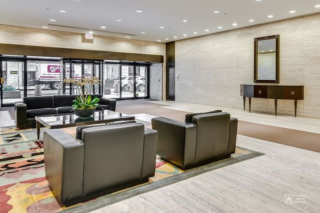 175 East Delaware Place, Unit 5609 Chicago, IL 60611 - Photo 26 of 28 a kitchen with stainless steel appliances granite countertop a sink and a microwave
