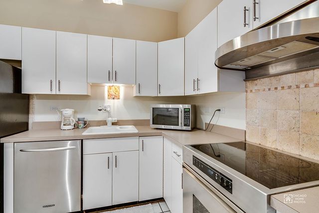 175 East Delaware Place, Unit 5609 Chicago, IL 60611 - Photo 4 of 28 a kitchen with stainless steel appliances granite countertop a sink stove and cabinets