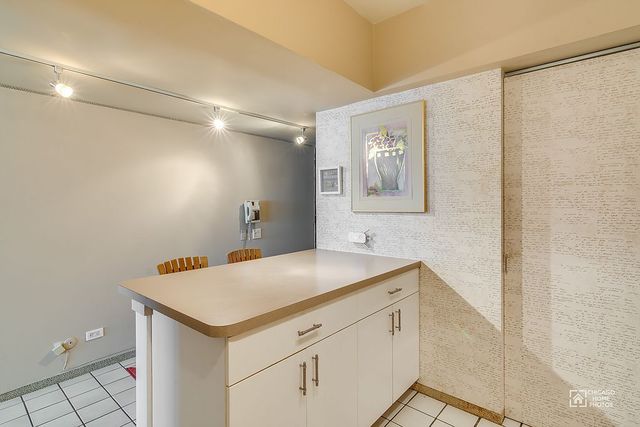 175 East Delaware Place, Unit 5609 Chicago, IL 60611 - Photo 6 of 28 a utility room with a sink and cabinets