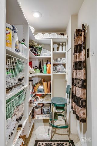 175 East Delaware Place, Unit 5609 Chicago, IL 60611 - Photo 7 of 28 a bedroom with furniture and a book shelf
