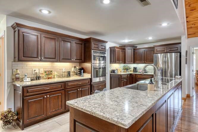 2121 Die Bend Road Murphy, NC 28906 - Photo 29 of 47 a kitchen with granite countertop stainless steel appliances and wooden cabinets