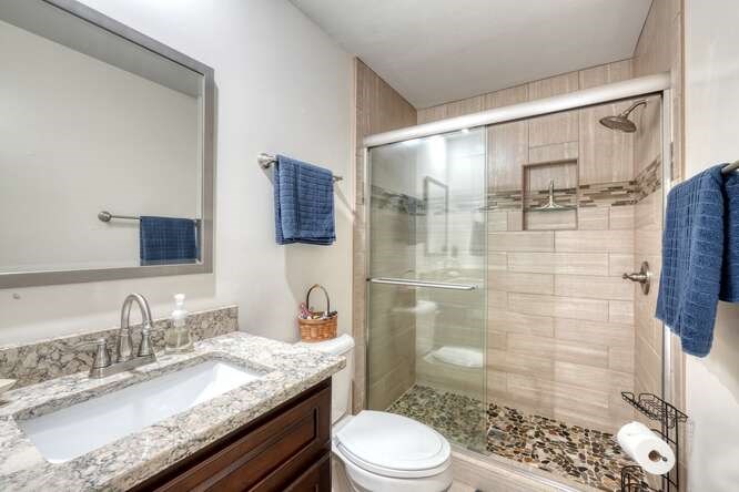 2121 Die Bend Road Murphy, NC 28906 - Photo 41 of 47 a bathroom with a granite countertop sink toilet a mirror and shower