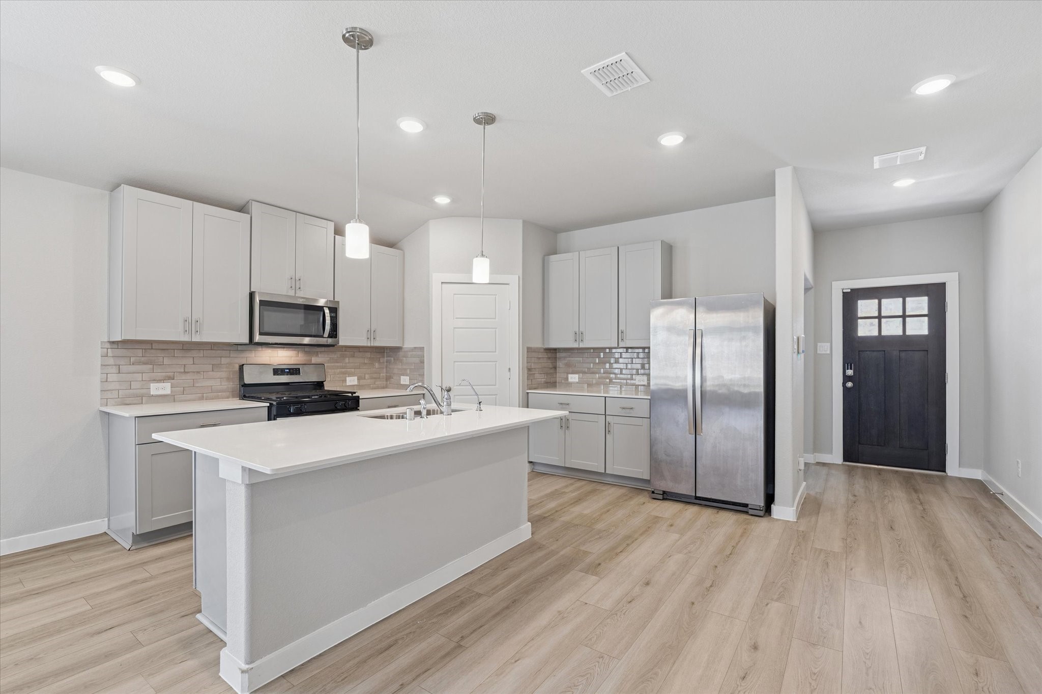 1510 King Rnch Road Conroe, TX 77301 - Photo 3 of 18 a kitchen with stainless steel appliances a refrigerator sink and microwave