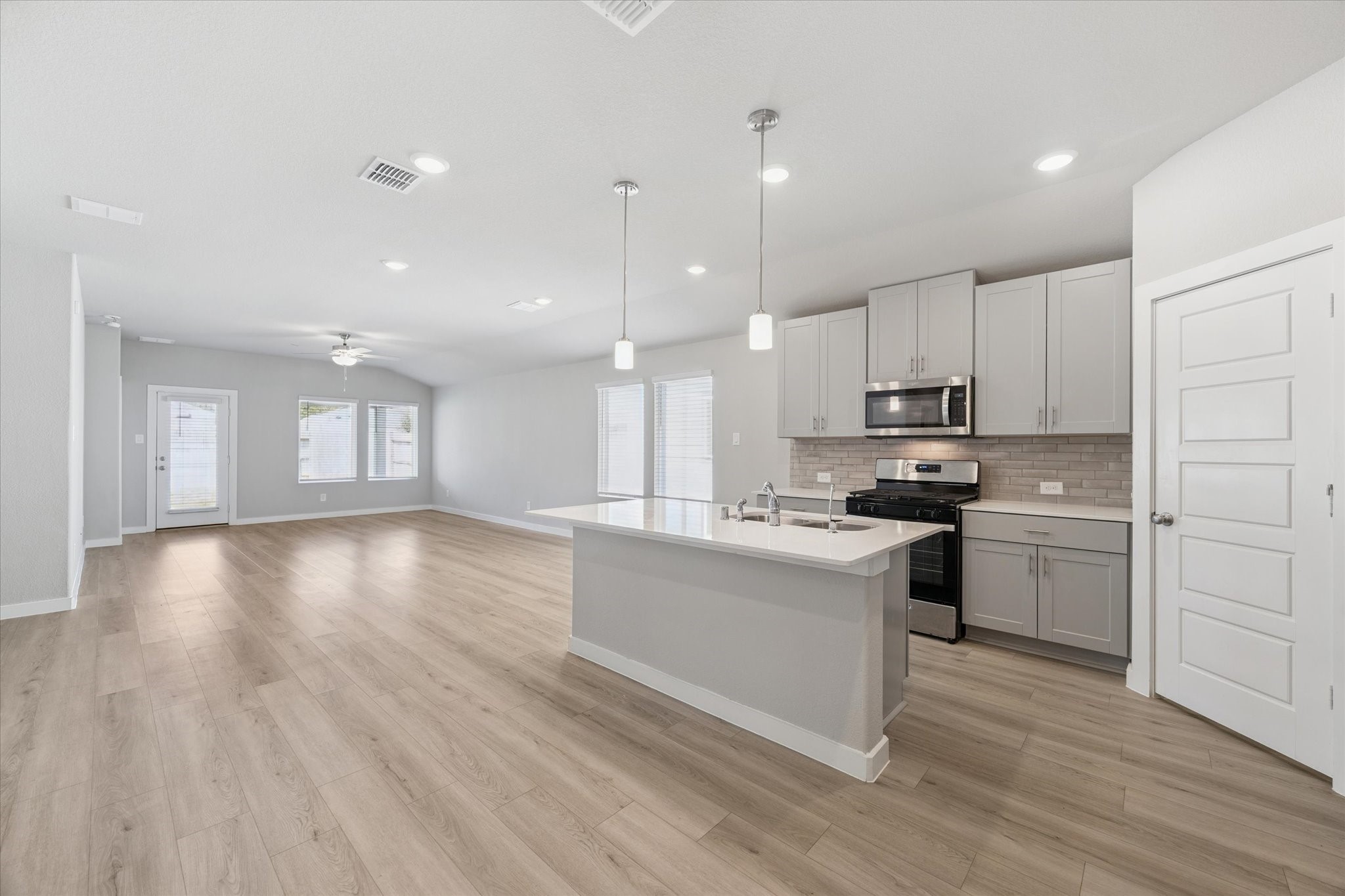1510 King Rnch Road Conroe, TX 77301 - Photo 5 of 18 a kitchen with a white wooden floor stove top oven and refrigerator