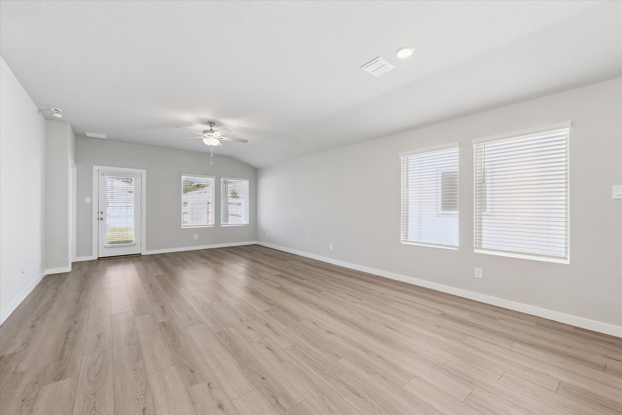 1510 King Rnch Road Conroe, TX 77301 - Photo 6 of 18 an empty room with wooden floor and windows