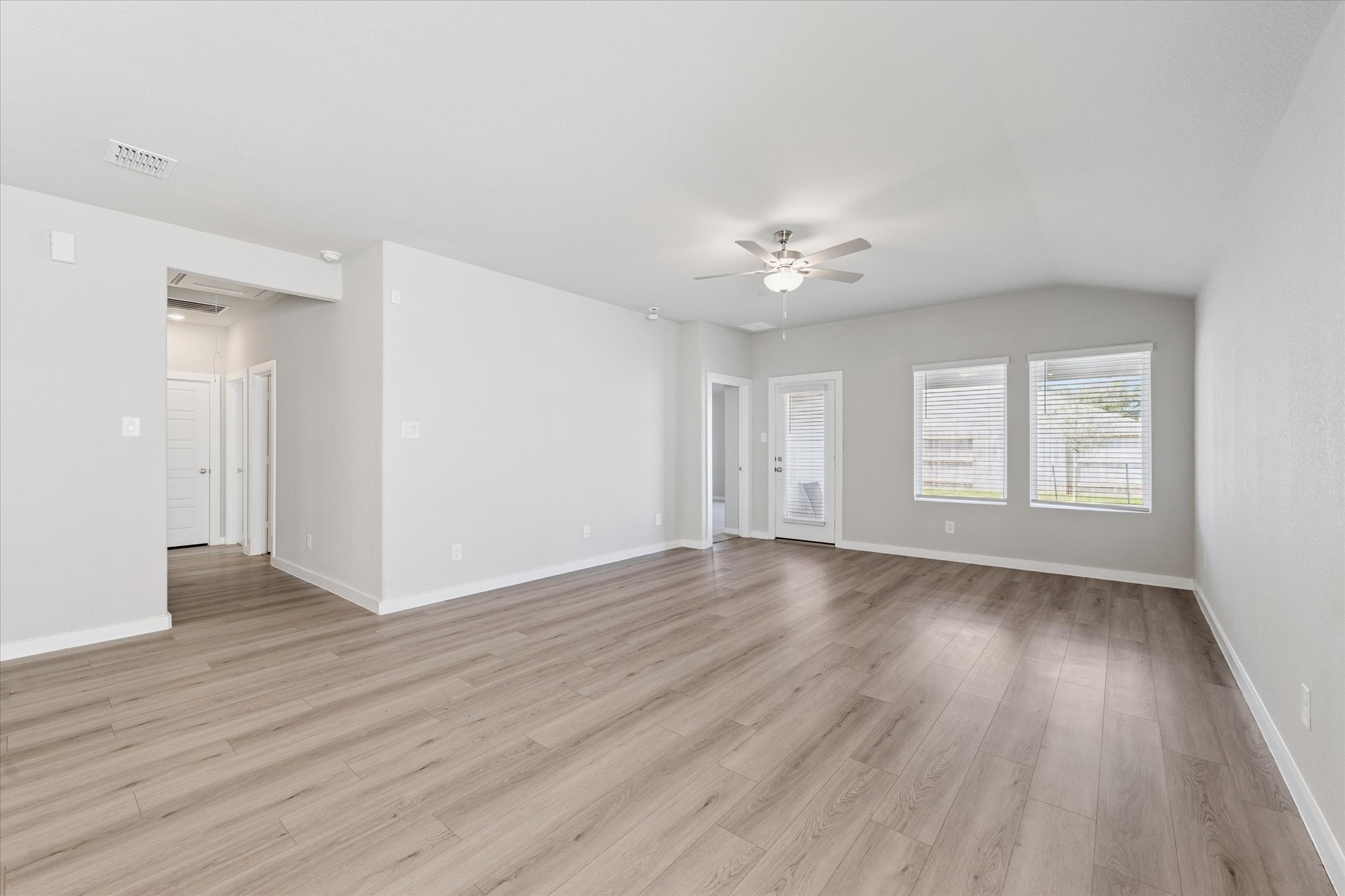 1510 King Rnch Road Conroe, TX 77301 - Photo 7 of 18 an empty room with wooden floor and windows