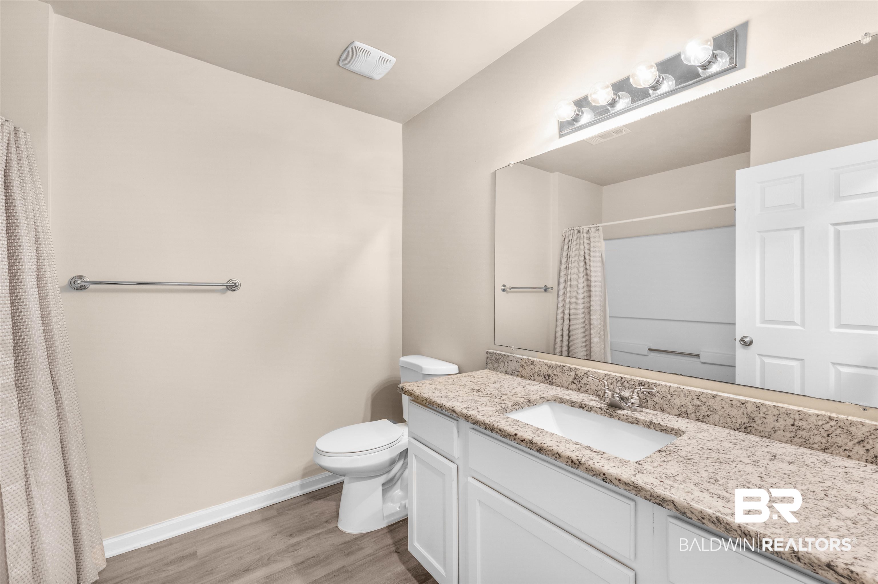 1517 Regency Road, Unit 85 Gulf Shores, AL 36542 - Photo 15 of 32 Bathroom with toilet, vanity, and wood-type flooring